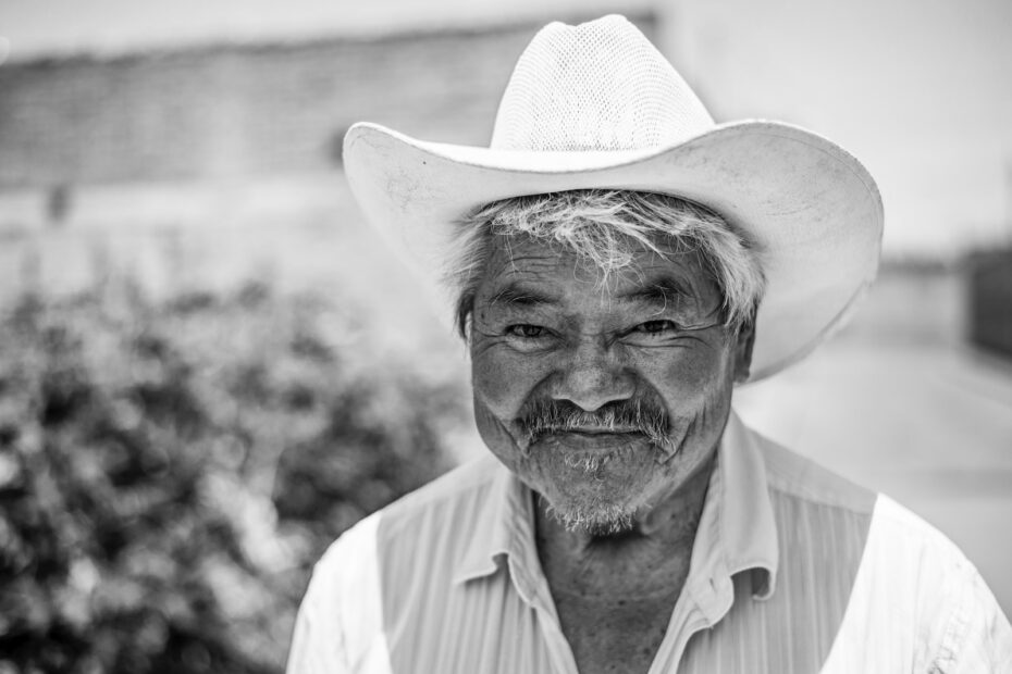 grayscale photo of man wearing cowboy hat